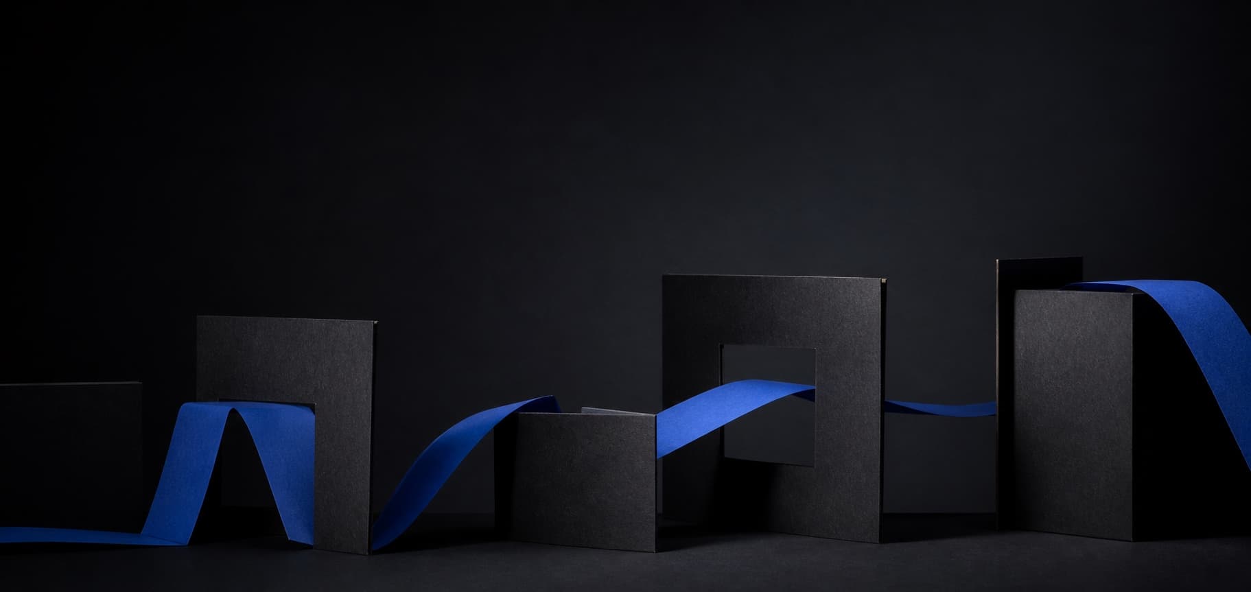 A cobalt paper path moving through a sequence of graphite structures.